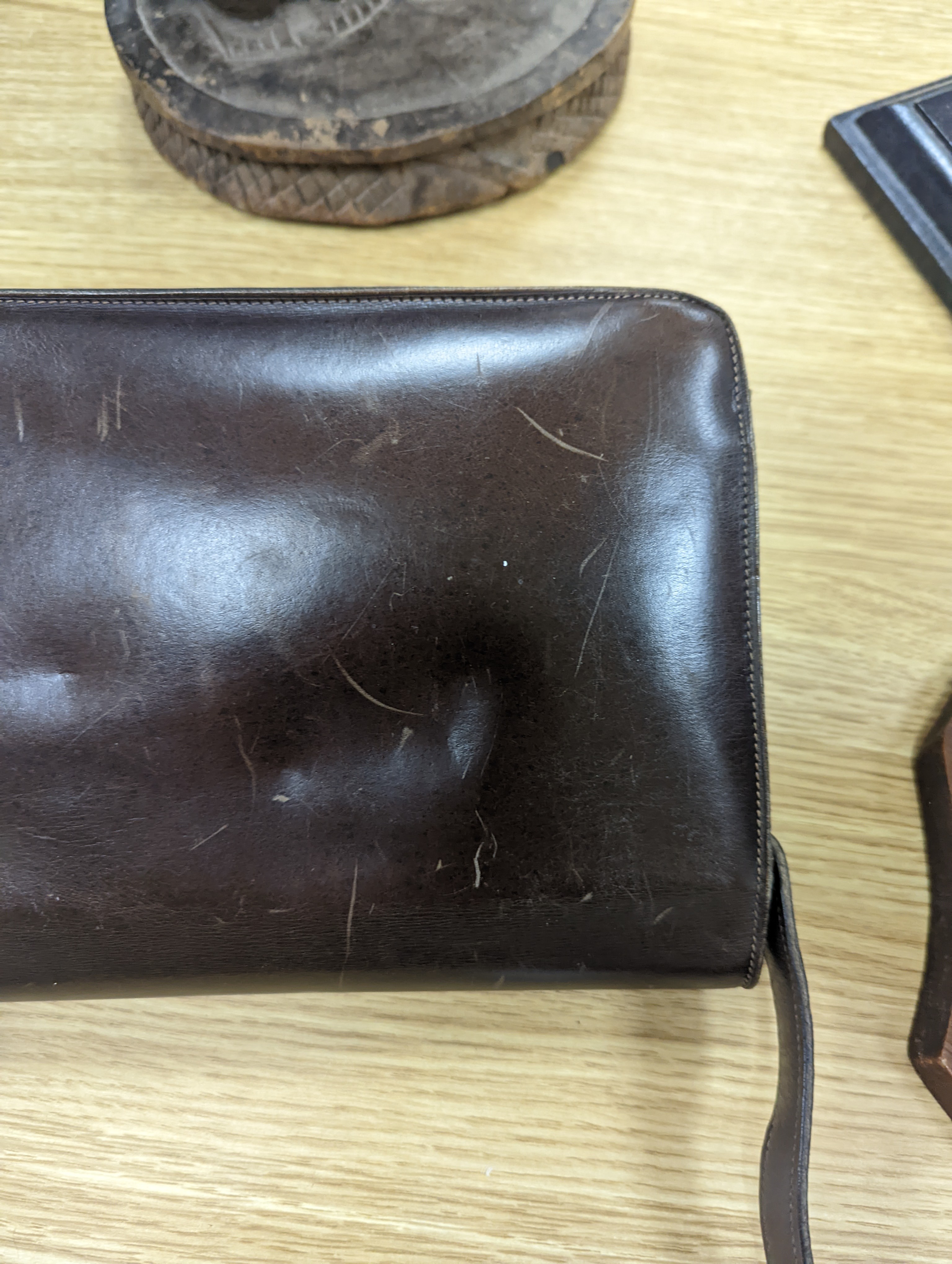 A vintage brown leather handbag stamped 